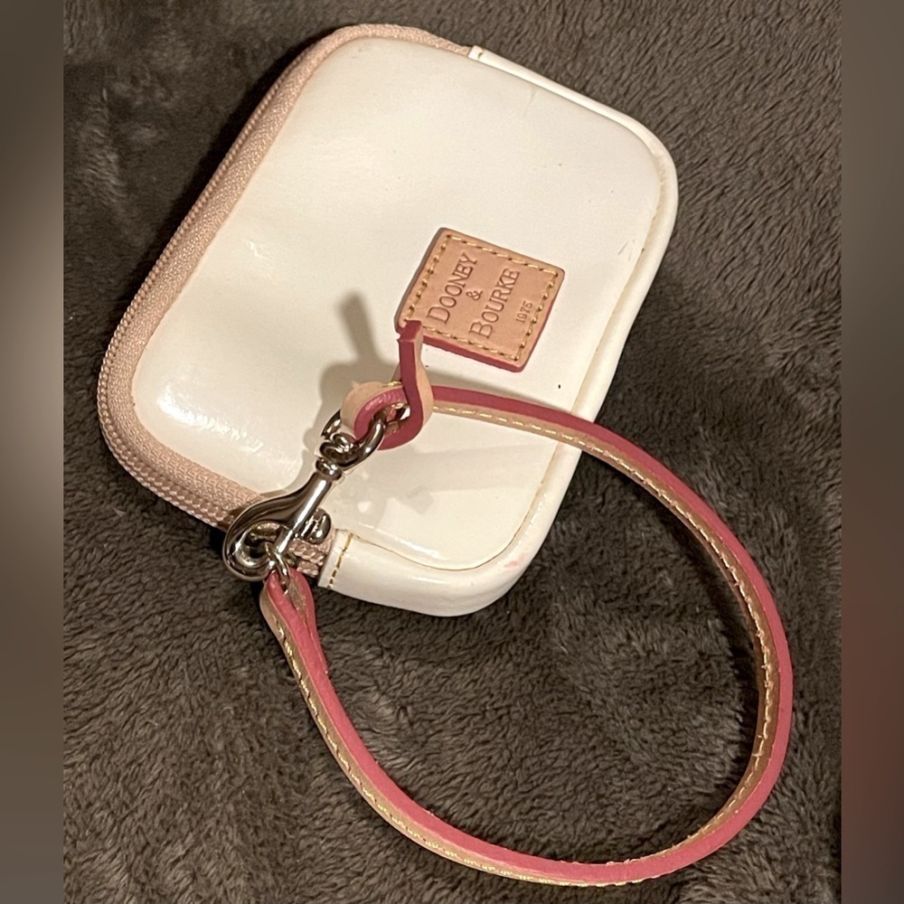 Dooney & Bourke cream patent leather wristlet with an ID pocket‎ on back